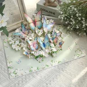 Handmade 3D pop-up greeting card featuring colorful butterflies and white flowers