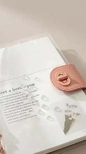 Close-up of transparent PVC notebook cover with elegant rose gold metal turn-lock.