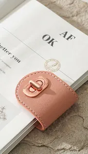 Close-up of rose gold rotating metal clasp on pink leather notebook strap