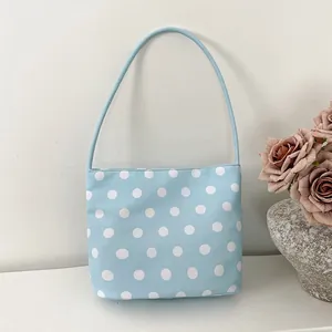 Light blue nylon shoulder bag with white polka dots, ideal for casual use or gift giving