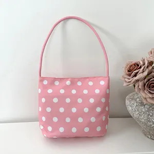 Pink nylon shoulder bag with white polka dots, stylish underarm hobo bag for women.