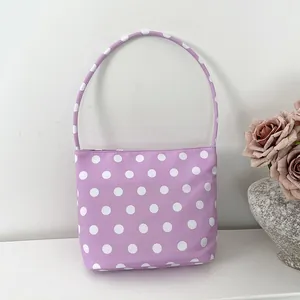 Chic lavender nylon underarm bag featuring a playful white polka dot pattern design