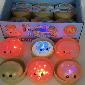 Close-up of glowing glitter bun squishy toys with LED lights in mystery display box