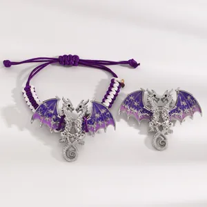 Detailed view of a vintage purple enamel dragon bracelet and brooch set with silver finish
