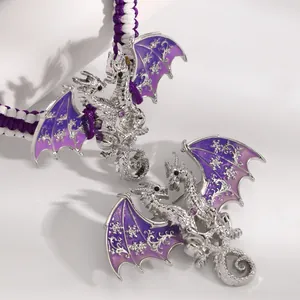Detailed view of vintage purple enamel dragon charm on a silver-toned braided bracelet