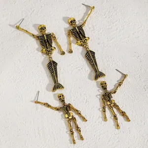 Close-up view of gold gothic skeleton and mermaid skeleton dangling earrings for Halloween