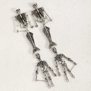 Detailed view of Gothic skeleton and mermaid skeleton drop earrings in antique silver finish