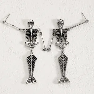 Detailed view of silver gothic mermaid skeleton earrings with intricate bone structure