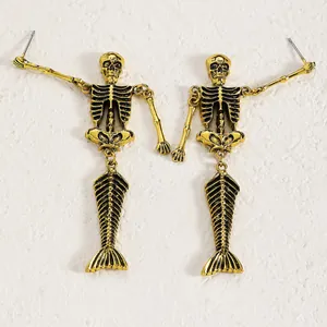 Detailed shot of gothic vintage golden skeleton mermaid drop earrings for Halloween