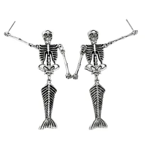 Close-up of gothic antique silver skeleton mermaid earrings with hollowed ribs and fish bone tail