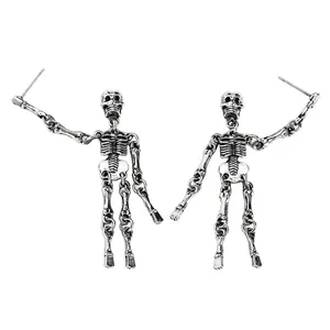 Detail macro view of vintage gothic silver skeleton dangle earrings for Halloween