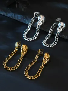 Detailed view of gothic punk skull earrings featuring gold and silver curb chain loops.