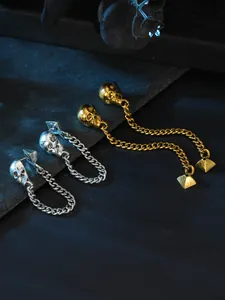 Close-up of gothic skull chain earrings in gold and silver finish, perfect for Halloween.