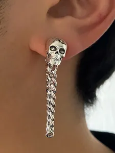 Detailed view of gothic punk skull earring with silver chain dangle on model ear