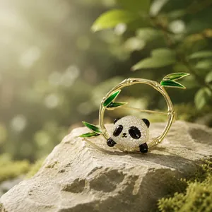 Close-up of a panda brooch with sparkling stones and green bamboo enamel leaves