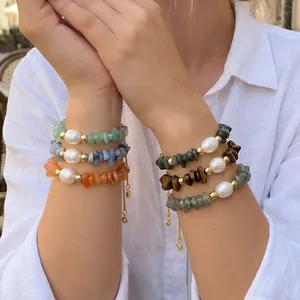Detailed view of handmade irregular stone bracelets with freshwater pearls worn on wrists