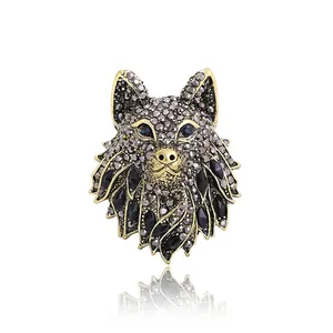 Ornate vintage wolf head brooch with sparkling grey rhinestones and black gems