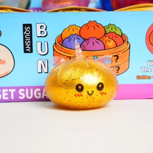 Glittery golden bun squishy toy with a cute face and unicorn horn
