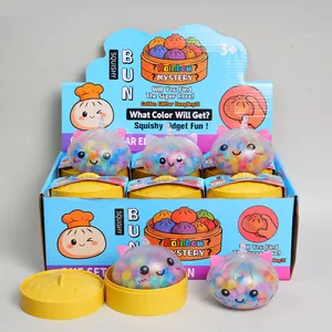 Set of colorful cat-shaped squishy bun toys in a blue display box with yellow steamers.