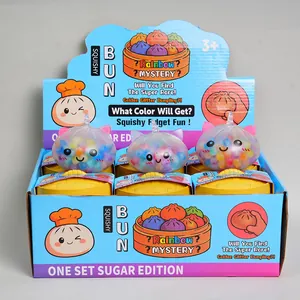 Display box showing colorful squishy bun fidget toys with mini steamer containers.