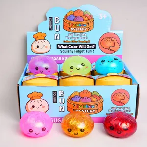 Colorful glitter bun squishy fidget toys with steamers in a blue retail display box