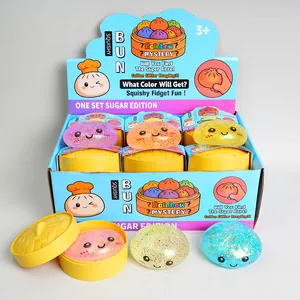 Set of colorful glitter maltose squishy bun toys with individual yellow steamers in a display box