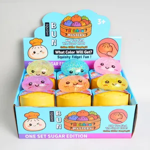 Colorful glitter dumpling squishy fidget toys in individual yellow steamer boxes display set