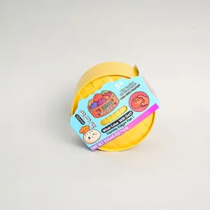 Detailed view of the bun squishy fidget toy set in its yellow steamer packaging