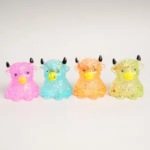 Detailed view of four colorful glitter highland cow squishy toys for stress relief