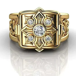 Macro view of intricately carved gold flip ring with micro-inlaid diamonds.
