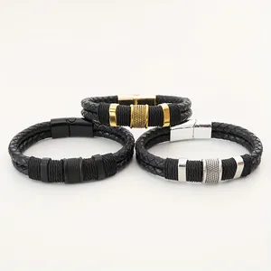 Detail of three braided leather bracelets for men in gold, silver, and black finishes.