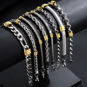 Detail view of various stainless steel bracelets with gold-tone accents on a black stand.