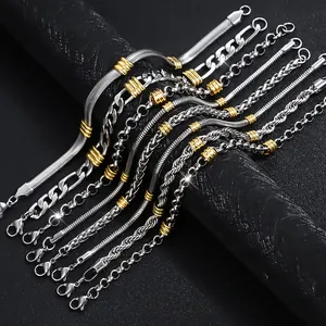 Collection of various stainless steel hip-hop bracelets with gold beads on black background