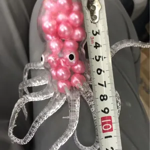 Handheld transparent TPR squishy octopus toy filled with pink pearls for stress relief