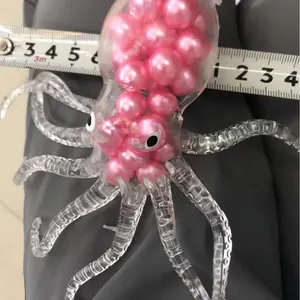 Transparent octopus stress relief toy with pink beads and size measurement