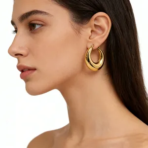 Close-up of a woman wearing chunky 18K gold-plated stainless steel hollow hoop earrings