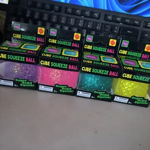 Macro view of four colorful glitter diamond squishy stress relief toys in packaging
