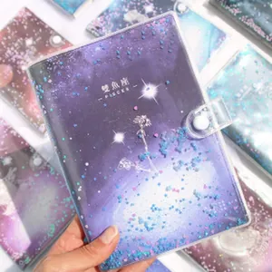 Detailed macro view of dreamy purple starry notebook cover with floating star glitter