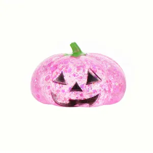 Pink glitter Halloween pumpkin squishy stress relief toy with Jack-o'-lantern face