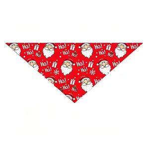 Close-up detail of a festive red Christmas pet bandana with Santa Claus print patterns