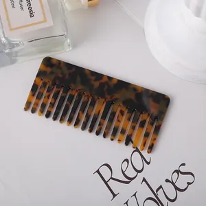 Close-up detail of a tortoiseshell acetate wide-tooth comb with elegant pattern