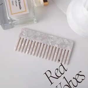 Detailed view of the marble-textured acetate wide-tooth comb for hair styling