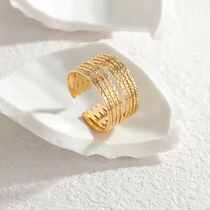 Detail view of a luxury gold geometric multi-line hollow open ring in stainless steel