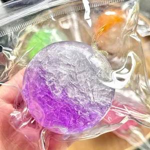 Close-up of creative purple ice cube texture squeeze ball in vacuum packaging for stress relief