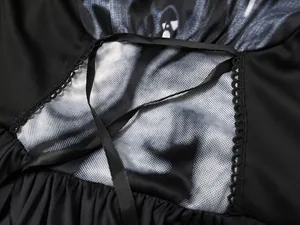 Detailed close-up view of Halloween witch dress featuring skull print and lace trims