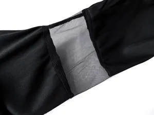 Detail of black witch dress featuring transparent mesh panel and fine stitching