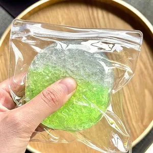 Close-up detail of a green sugar crushed ice squishy toy inside a clear zipper bag.