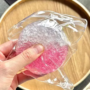 Close-up of handmade squeeze stress ball toy with pink and white crystalline texture