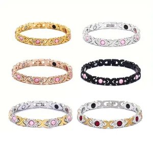 Display of six magnetic therapy bracelets in gold silver and black with pink stones