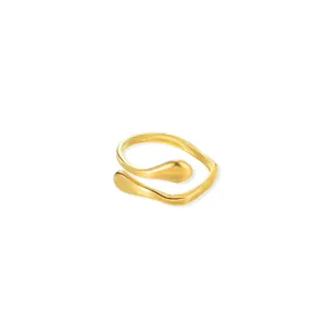 Detailed macro view of an elegant gold wavy open ring with smooth drop-shaped ends